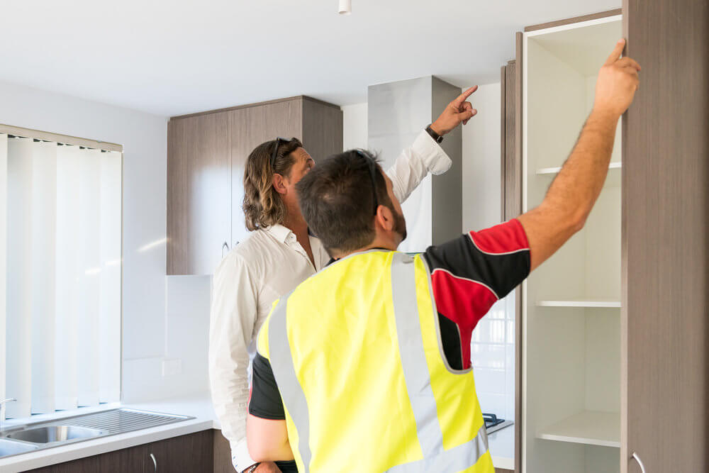 Contractor discussing work inside a property